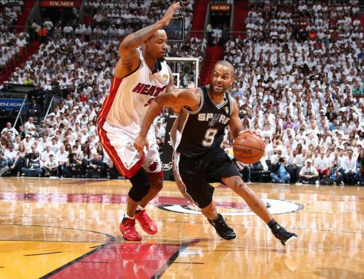 Tony Parker of the San Antonio Spurs drives against Rashard Lewis of the Miami Heat during Game Four of the 2014 NBA Finals at American Airlines Arena in Miami, Florida on June 12, 2014. Credit: Nathaniel S. Butler/NBAE/Getty Images